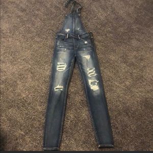 American Eagle distressed long skinny bibs